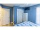 Blue bedroom with white closet and wood floor at 1314 Lajolla Cir, The Villages, FL 32159