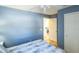 Blue bedroom with white doors and wood floor at 1314 Lajolla Cir, The Villages, FL 32159