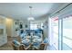 Bright dining area with glass-top table and wicker chairs, adjacent to living room at 1314 Lajolla Cir, The Villages, FL 32159