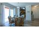 Casual dining area with a glass table and wicker chairs near sliding doors at 1314 Lajolla Cir, The Villages, FL 32159