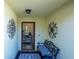 Inviting entryway with a bench and decorative wall art at 1314 Lajolla Cir, The Villages, FL 32159