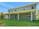 Expansive backyard with covered patio, lush lawn, and ample space for outdoor entertaining, ideal for relaxation at 14255 Crest Palm Ave, Windermere, FL 34786