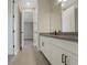 Bathroom featuring a double vanity, stylish tile floors, and modern fixtures, offering a spa-like experience at 14255 Crest Palm Ave, Windermere, FL 34786