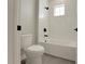 Bathroom featuring white subway tile, a shower and bathtub combination, and dark fixtures at 14255 Crest Palm Ave, Windermere, FL 34786
