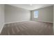 Large bedroom with neutral walls, plush carpet and a window with a neighborhood view at 14255 Crest Palm Ave, Windermere, FL 34786