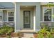 Inviting front entrance with decorative glass door and stone accents on the exterior facade at 14255 Crest Palm Ave, Windermere, FL 34786