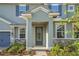 Attractive entryway featuring a decorative glass door and stone detailing on the home's facade at 14255 Crest Palm Ave, Windermere, FL 34786
