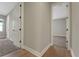 Hallway with two doorways, one leading to a carpeted room and the other to another carpeted room at 14255 Crest Palm Ave, Windermere, FL 34786