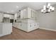 Well-lit kitchen with white cabinets, modern appliances, and hardwood floors at 14255 Crest Palm Ave, Windermere, FL 34786