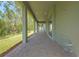 Long, covered back patio offers outdoor living space with brick pavers and scenic backyard views at 14255 Crest Palm Ave, Windermere, FL 34786
