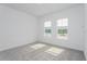 Well-lit bedroom featuring two windows and grey carpet at 14256 Crest Palm Ave, Windermere, FL 34786