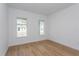 Bright bedroom with wood-look floors and large windows at 14256 Crest Palm Ave, Windermere, FL 34786