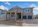 Two-story home with gray siding, two-car garage, and covered porch at 14256 Crest Palm Ave, Windermere, FL 34786