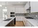 Modern kitchen with white cabinets, quartz countertops, and stainless steel appliances at 14256 Crest Palm Ave, Windermere, FL 34786