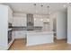 Modern kitchen featuring white cabinets, quartz countertops, and stainless steel appliances at 14256 Crest Palm Ave, Windermere, FL 34786