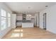 Modern kitchen with white cabinets, gray tile backsplash and kitchen island at 14256 Crest Palm Ave, Windermere, FL 34786