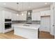 Modern kitchen with white cabinets, quartz countertops and stainless steel appliances at 14256 Crest Palm Ave, Windermere, FL 34786