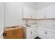 Clean laundry room with white cabinets and quartz countertops at 14256 Crest Palm Ave, Windermere, FL 34786