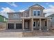 Two story house with a light brown exterior and double car garage at 14421 Crest Palm Ave, Windermere, FL 34786