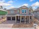 Two-story house with brown double doors and a stone driveway at 14421 Crest Palm Ave, Windermere, FL 34786