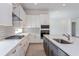 Modern kitchen with white cabinets, gas cooktop and an island at 14421 Crest Palm Ave, Windermere, FL 34786