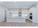 Modern kitchen with white cabinets, quartz countertops, and stainless steel appliances at 14421 Crest Palm Ave, Windermere, FL 34786