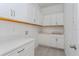 Bright laundry room with white cabinets and countertop at 14421 Crest Palm Ave, Windermere, FL 34786