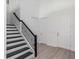 Modern staircase with black railings and white risers at 14421 Crest Palm Ave, Windermere, FL 34786