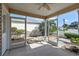 Enclosed patio with neutral screens offering views of the home's exterior landscaping and blue skies at 17478 Se 77Th Sycamore Ave, The Villages, FL 32162