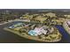 Aerial view of community clubhouse with tennis courts, pool, parking and lake at 2440 Pawtucket Pass, Mount Dora, FL 32757
