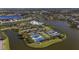 An aerial view of a lakeside community with tennis courts, a clubhouse, and a pool at 2440 Pawtucket Pass, Mount Dora, FL 32757