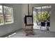 Sunlit living area featuring a large window, access to a patio, and sleek design elements at 2440 Pawtucket Pass, Mount Dora, FL 32757