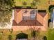 Aerial view showcasing home's roofline and screened enclosure at 2502 Loch Ness Ct, Leesburg, FL 34788