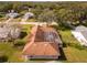 An aerial view of the house showing the roof and the surrounding landscape at 2502 Loch Ness Ct, Leesburg, FL 34788