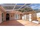 Enclosed patio with hexagonal tile flooring, leading to a backyard at 2502 Loch Ness Ct, Leesburg, FL 34788