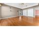 Bright bedroom with hardwood floors, tray ceiling, and white closets for ample storage at 2502 Loch Ness Ct, Leesburg, FL 34788