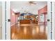 Hardwood floor living room, open to kitchen and backyard at 2502 Loch Ness Ct, Leesburg, FL 34788