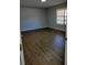 Bright bedroom with wood-look floors and large window at 33710 Linda Ln, Leesburg, FL 34788