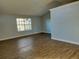 Bright living room with vaulted ceiling and wood-look floors at 33710 Linda Ln, Leesburg, FL 34788