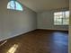 Spacious living room with wood-look floors and large windows at 33710 Linda Ln, Leesburg, FL 34788