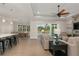 Open-concept living room with tile floors, ceiling fan, and sliding glass doors to the pool at 38805 Ranch Gate Blvd, Umatilla, FL 32784