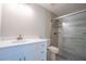 Bathroom featuring a modern vanity and walk-in shower with tiled walls and a glass door at 504 4Th Ave, Wildwood, FL 34785