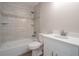 Bright bathroom featuring a modern vanity and a shower/tub combo with tiled walls at 504 4Th Ave, Wildwood, FL 34785