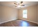 Bright bedroom with wood-look floors, ceiling fan and natural light from a window at 504 4Th Ave, Wildwood, FL 34785