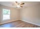 Bedroom with wood-look floors, ceiling fan and natural light from a window at 504 4Th Ave, Wildwood, FL 34785