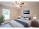 Tastefully designed bedroom featuring a plush bed, stylish rug, and natural light from a window at 504 4Th Ave, Wildwood, FL 34785