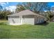 Back exterior view of home showcasing the backyard and patio area at 504 4Th Ave, Wildwood, FL 34785