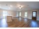 Spacious living room with white kitchen island, hardwood flooring, and a dark wood entry door at 504 4Th Ave, Wildwood, FL 34785