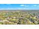 Expansive aerial view of a neighborhood with lush greenery, lakes, and clear blue skies at 929 Magnolia Blossom Ct, Apopka, FL 32712