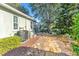 Landscaped backyard featuring a stone pathway, mature trees, and a glimpse of the house's exterior at 929 Magnolia Blossom Ct, Apopka, FL 32712